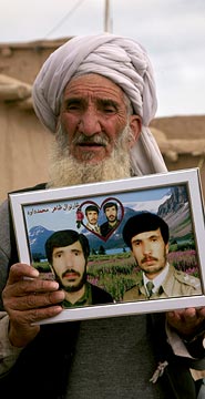Haji Sharabuddin holds up a photo of his sons Haji Sharabuddin holds up a photo of his sons
