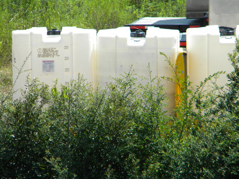 Corner of Canal Road and I-10, in Gulfport, at the Gulfport site used as a BP staging area. Corexit Tanks. September 1, 2010. (Photo: Shirley Tillman)