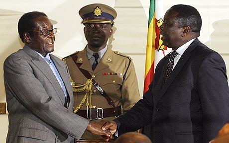 Robert Mugabe shakes hands with Morgan Tsvangirai