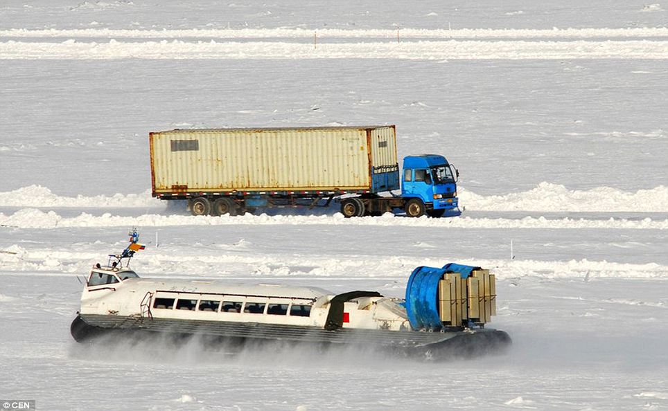 The bitterly cold weather has meant that the Hei Longjiang river in north-east China has frozen so thickly that lorries can cross it from Russia leading to a boom in trade