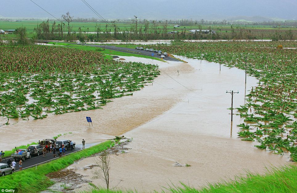 Motorists wait for water to subside over the Bruce Highway outside of Innisfail on February 3,
 2011 in Innisfail, Australia. 