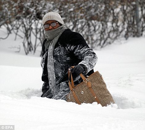 A woman walks through the high snow in Downtown Chicago, Illinois, USA on 02 February 2011