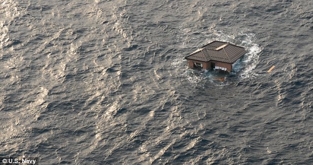 Adrift: A whole house bobs in the Pacific Ocean off the coast of Japan. An enormous field of debris was swept out to sea following the earthquake and tsunami