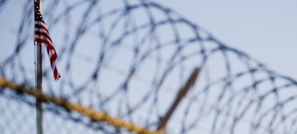 The flag and barbed wire within a detention facility at Guantanamo Bay. (photo: Getty Images)