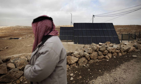 MDG : A Palestinian man looks at a solar panel in the southern West Bank village of Imneizil