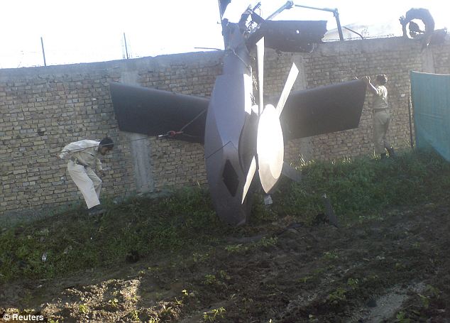 Aftermath: Part of a damaged helicopter is seen lying near the compound after US Navy SEAL commandos supposedly killed bin Laden
