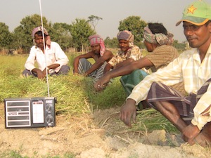 A group of farmers in northwestern Bangladesh tune into 'Agriculture and Life', a radio show on farming. Credit: Naimul Haq/IPS