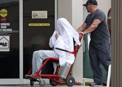 Bynes  wheeled between buildings at the Hillmont Psychiatric Center on July 25. Something is definitely not right here. Is she being re-programmed?