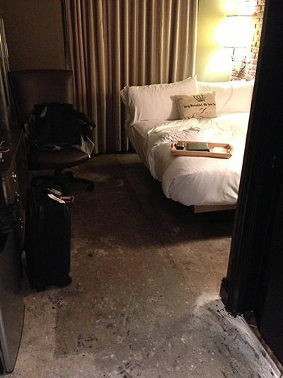 The floor is hard, dirty concrete, unlike any other room in the hotel.