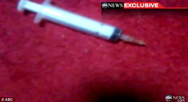 High: The medical officer appeared totally out of it after injecting himself with Ketamine, the used syringe is shown lying on the floor beside him 