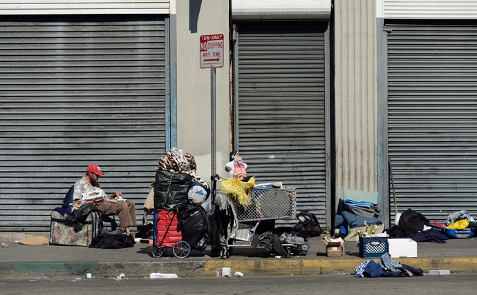Homeless people rest on a public sidewalk in downtown skid row area of Los Angeles, California. (Kevork Djansezian / Getty Images / AFP)