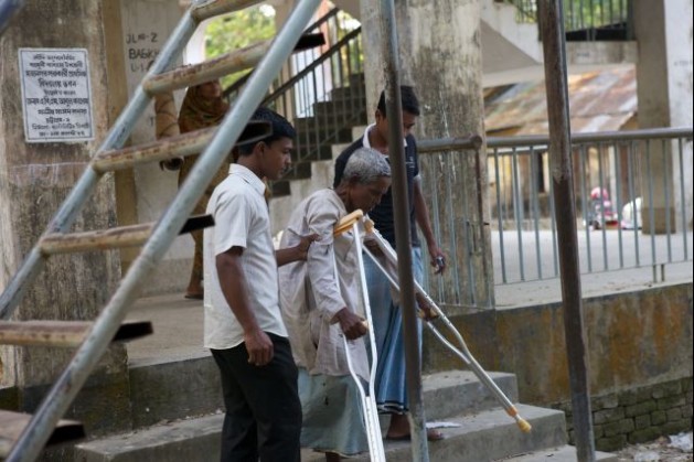 Disaster Risk Management Project (DRM). An elderly person with a disability goes down the stairs of the Cyclone shelter in Mohanagar, Sitakunda, Bangladesh. Credit: Brice Blondel/Handicap International