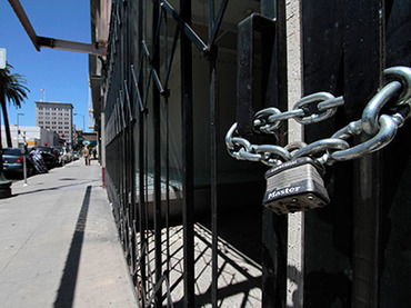Shuttered and padlocked businesses line Main Street in Stockton, California June 27, 2012 (Reuters/Kevin Bartram)