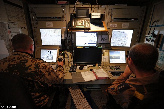 Pilot operators control an unmanned aerial vehicle (UAV) on a mission; drone operators typically work out of small bunkers such as these