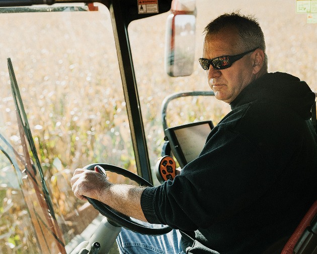 Huegerich, in his combine. He has no ideological problem with GMOs but has been experimenting with conventional seeds for financial reasons.
